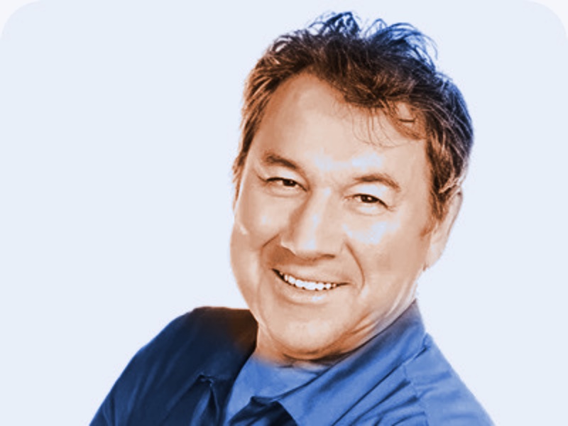 Portrait of Guido Leiendecker, smiling, with tousled hair, in a collared shirt